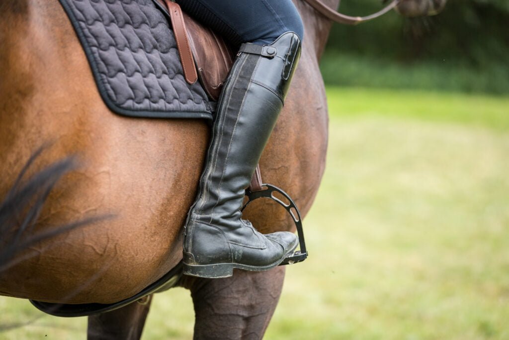 English rider on horse at horse show.