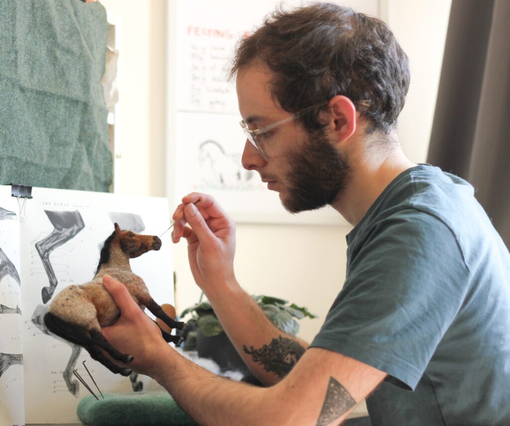 Tomás Varela of Needle Neddies working on a custom model.